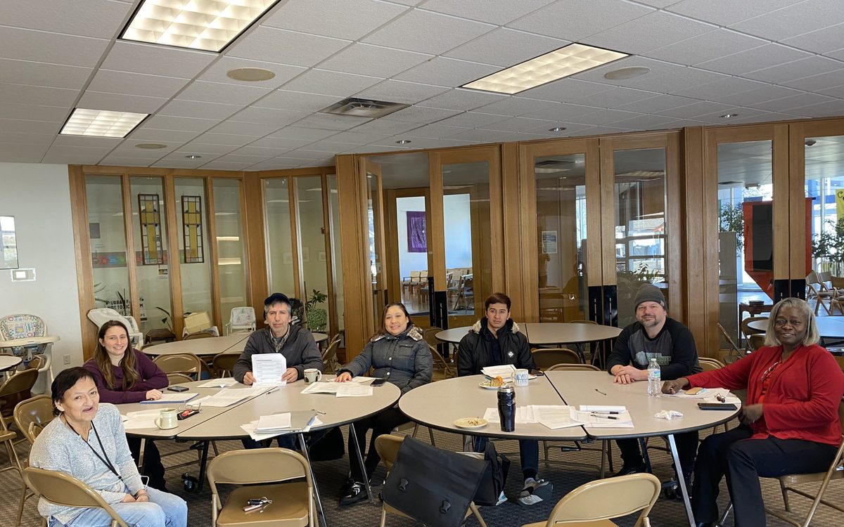 Participants seated around tables at a Participant Advisory Council meeting