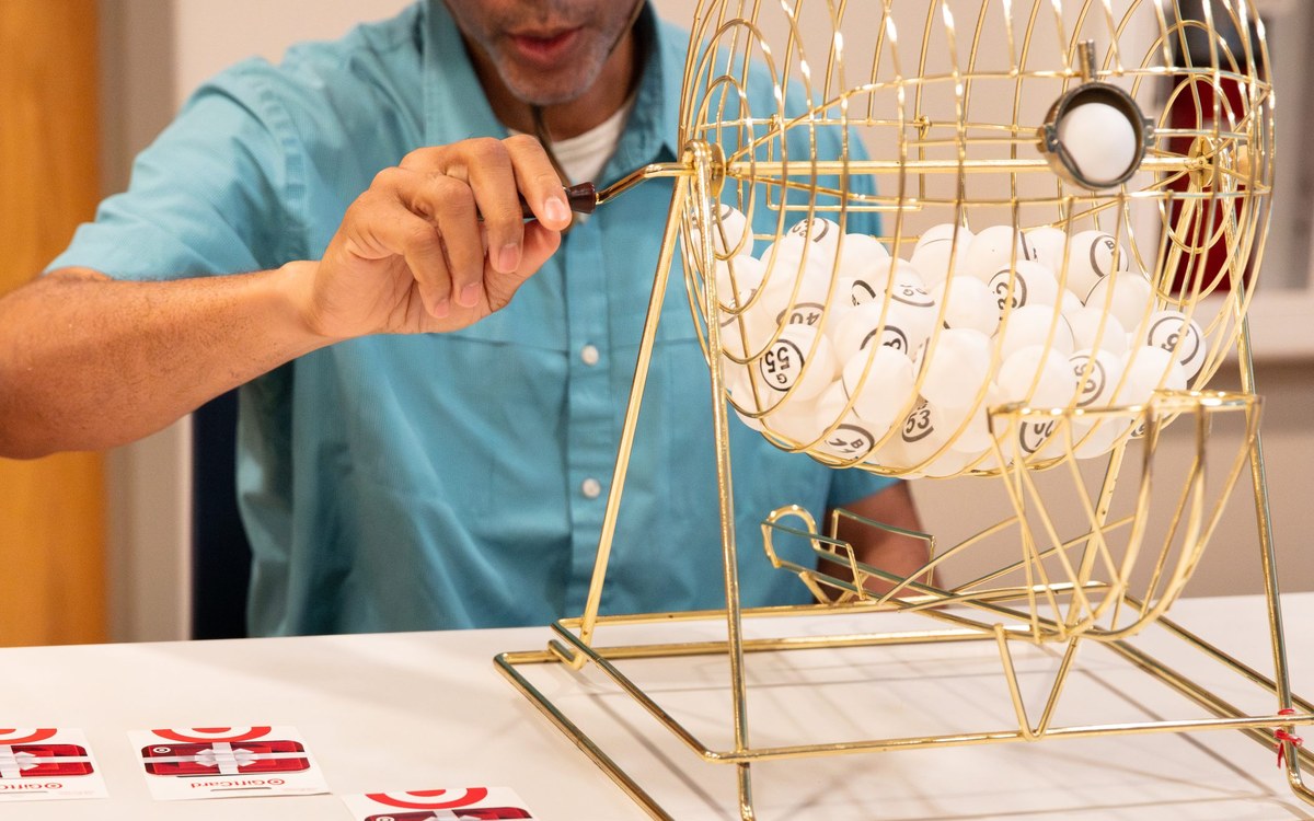 A volunteer spinning the bingo cage at the shelter