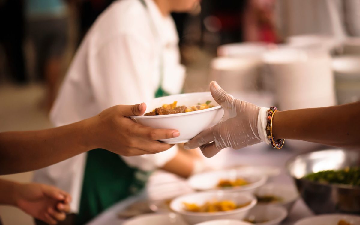 A volunteer serving a meal at the shelter