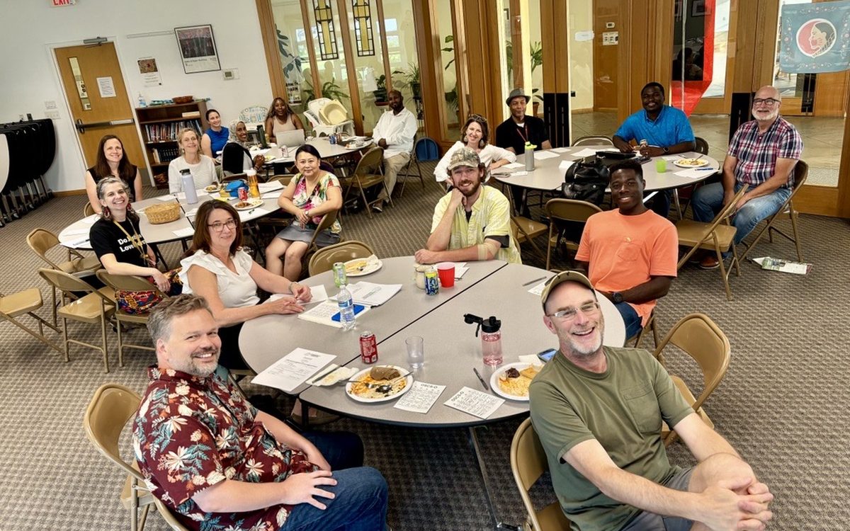Staff and board members of Our Saviour's Community Services sharing a meal